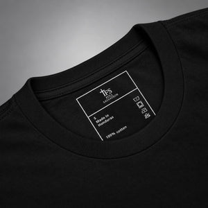 Close-up of the Full Salvation Apparel woven neck label, 100% cotton, made in Honduras