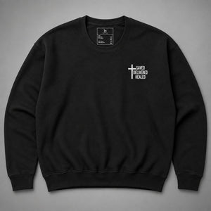 Black Saved Delivered Healed embroidered crew neck sweatshirt flat lay showing cross embroidery on the chest