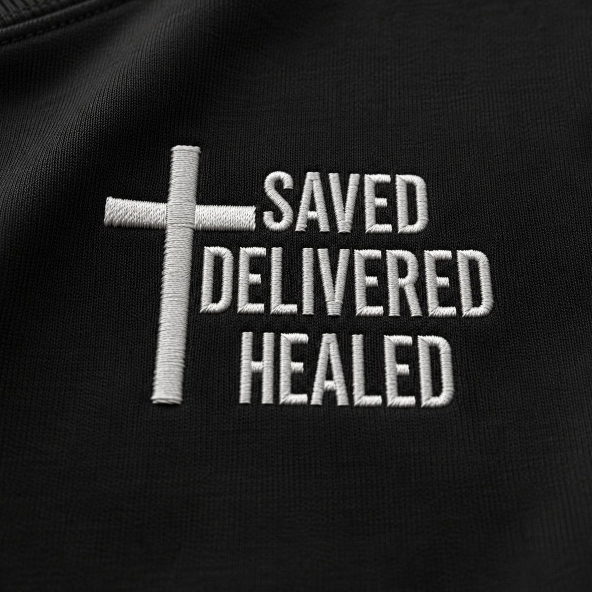 Close-up of the cross and Saved Delivered Healed embroidery on Full Salvation Apparel crew neck sweatshirt