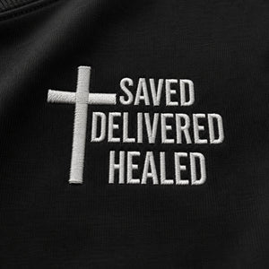 Close-up of the cross and Saved Delivered Healed embroidery on Full Salvation Apparel crew neck sweatshirt