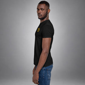 Man wearing a black Saved Delivered Healed embroidered cross t-shirt, side profile