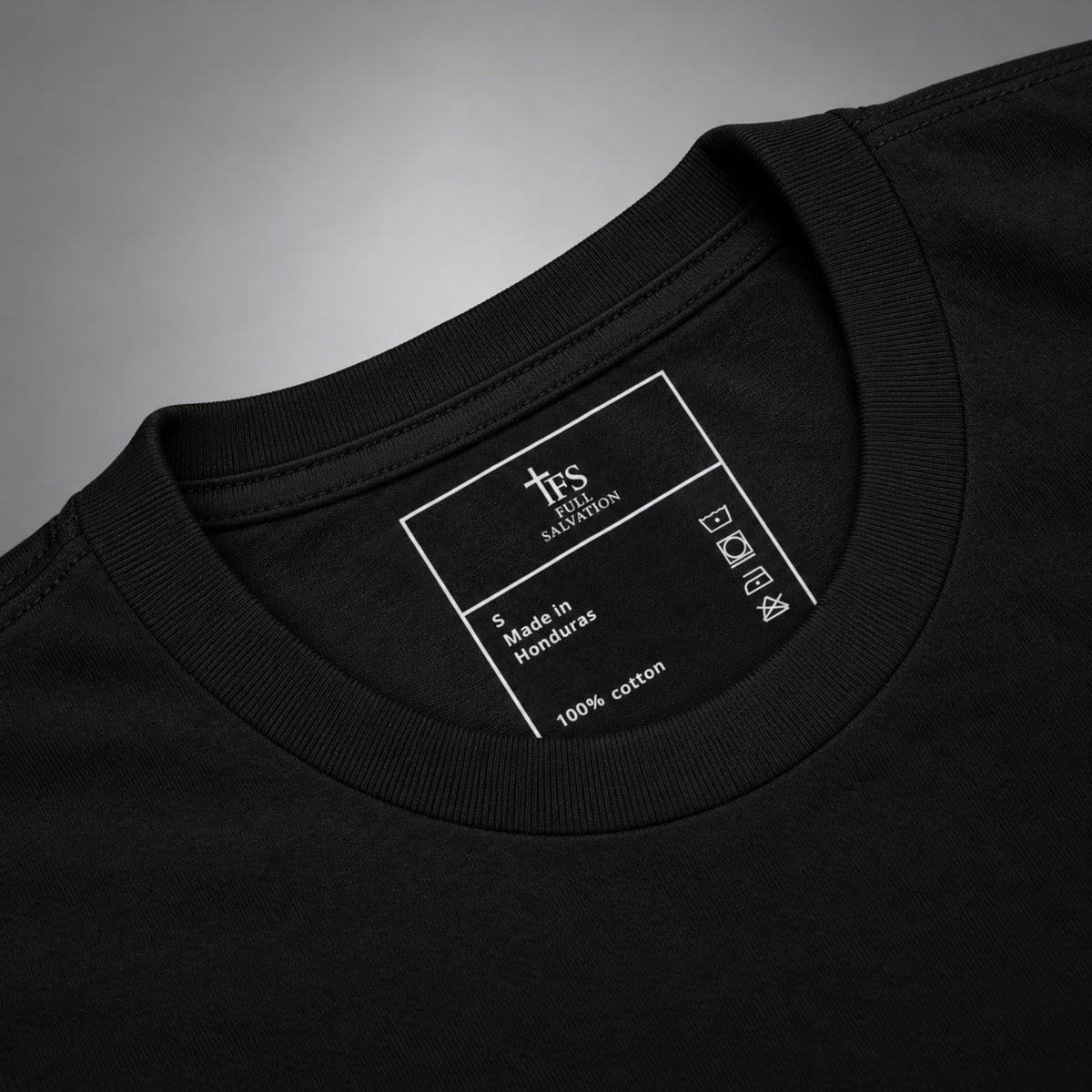 Close-up of the Full Salvation Apparel woven neck label, 100% cotton, made in Honduras