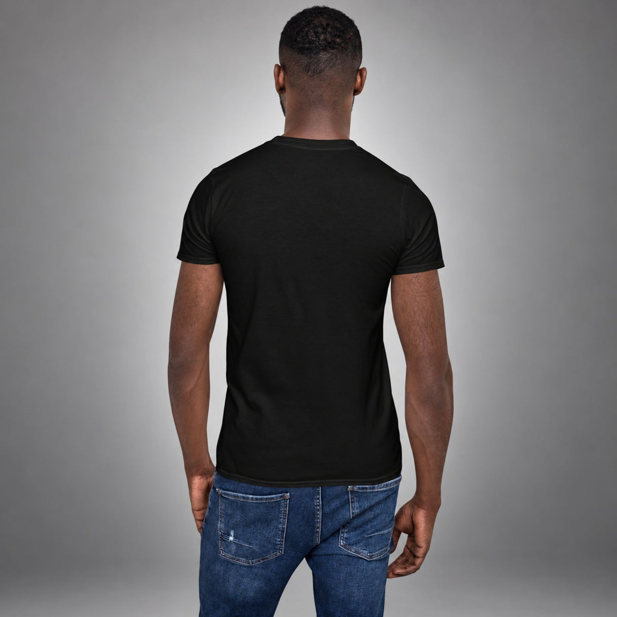 Man wearing a black Saved Delivered Healed embroidered t-shirt, back view
