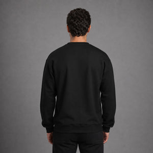 Back view of black Saved Delivered Healed embroidered crew neck sweatshirt on male model