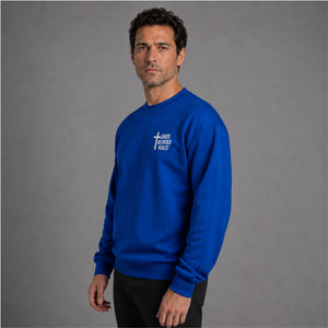 Man wearing royal blue Saved Delivered Healed embroidered crew neck sweatshirt