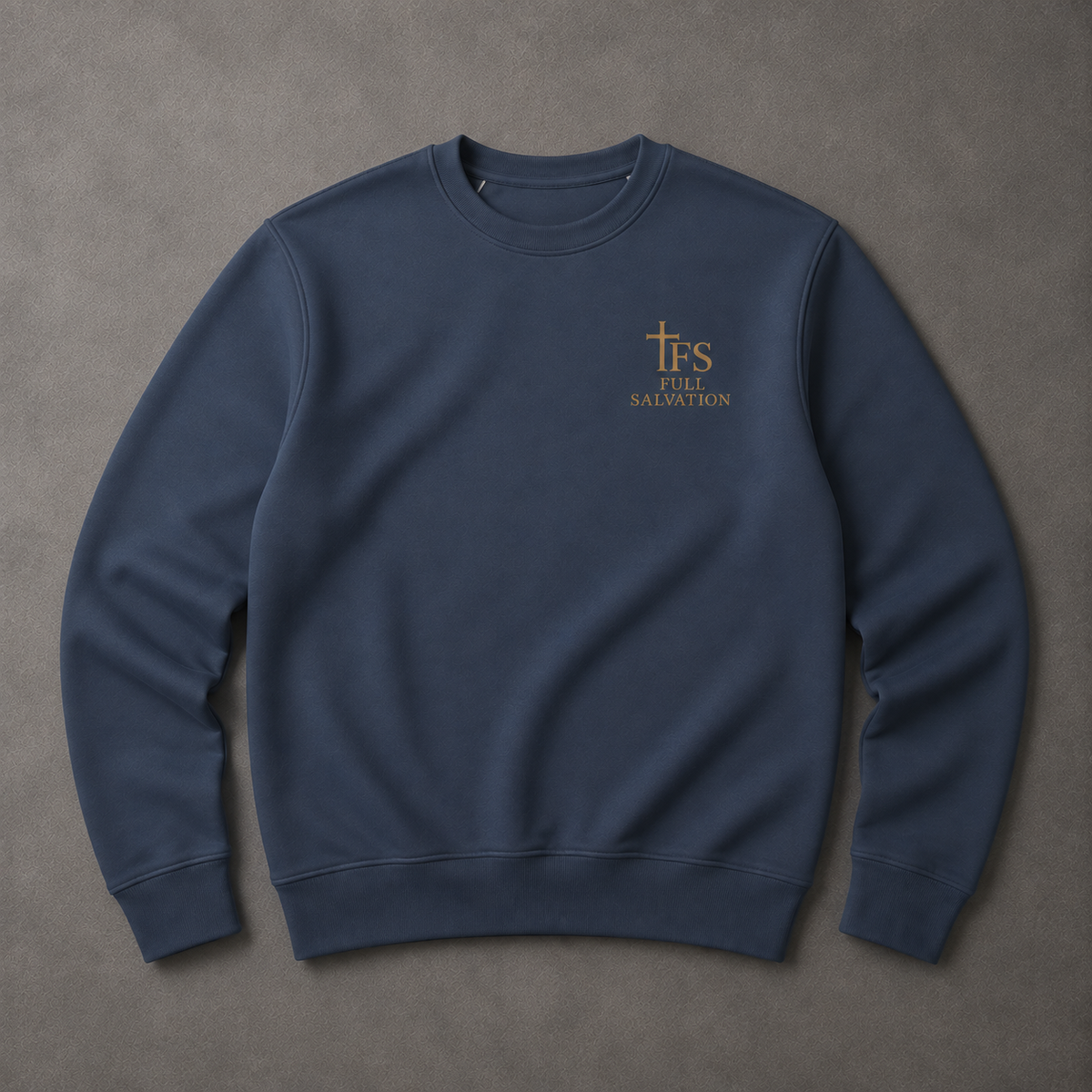 Flat lay of the Full Salvation Apparel Essential Organic Cotton Crewneck Sweatshirt in French Navy with embroidered gold cross emblem