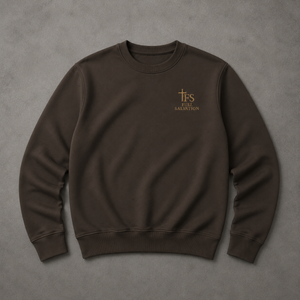 Flat lay of the Full Salvation Apparel Essential Organic Cotton Crewneck Sweatshirt in Deep Charcoal Grey with embroidered gold cross emblem